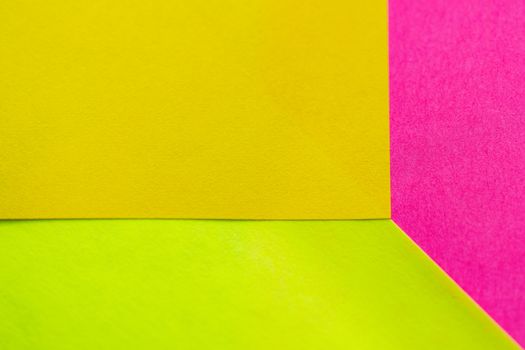 Yellow, green and pink paper pattern arranged in the background