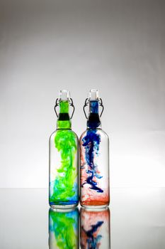 Two bottles with color smoke