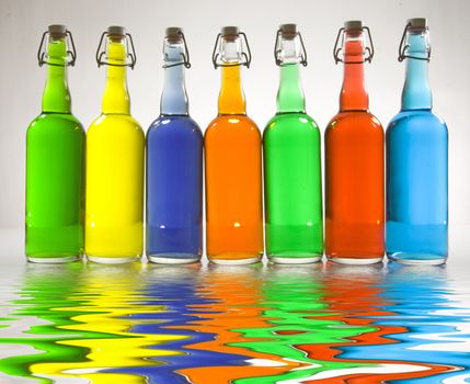 Colorful bottles reflected in water