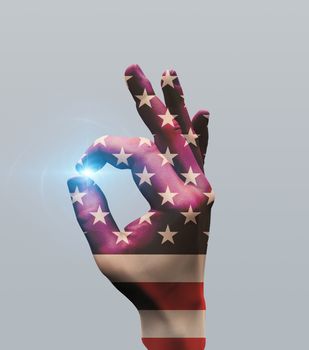 Human hand in US national colors shows OK
