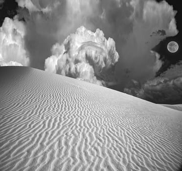 Clouds and moon over surreal desert .