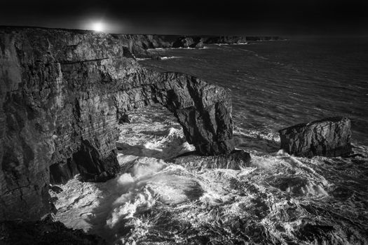 The Green Bridge of Wales at Castlemartin Pembrokeshire Wales UK black and white monochrome stock photo