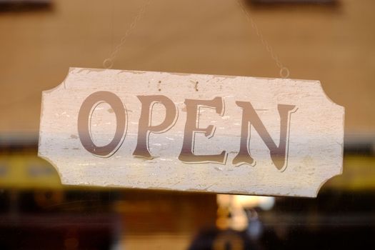 Open sign of a store behind a window