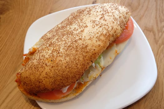 Whole wheat bread roll with tomato and mozzarella