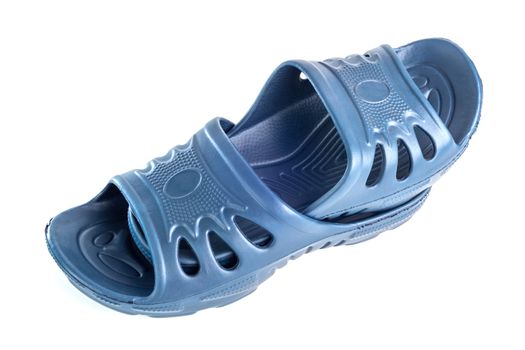 a pair of cheap durable blue rubber slippers one inside other isolated on white background.