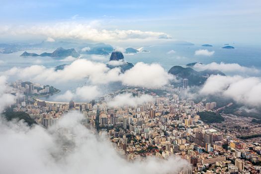Rio city center downtown panorama with coastline and Sugar Loaf mountain covered in clouds, Rio de Janeiro, Brazil