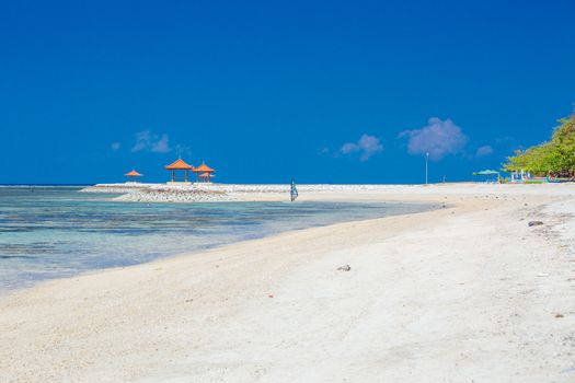 Beach scene and traditional Balinese boat on a Sanur beach in Bali, Indonesia