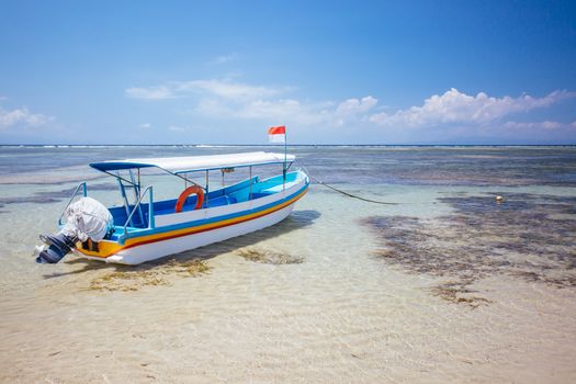 Beach scene and traditional Balinese boat on a Sanur beach in Bali, Indonesia