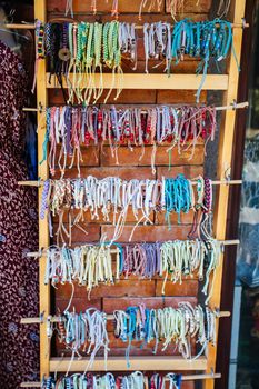 Sanur, Indonesia - September 6: A typical street scene with bracelets for sale in Sanur, Bali, Indonesia