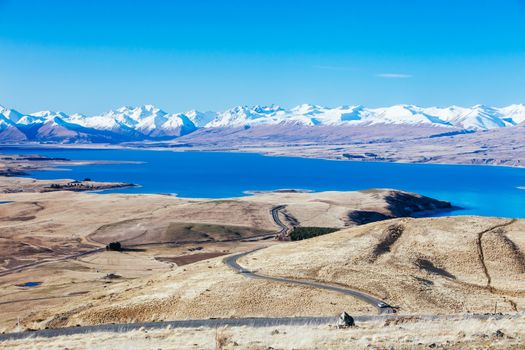 The view of the southern alps and Lake Alexandrina from Mt John Walkway and observatory area near Lake Tekapo on a clear spring evening in New Zealand