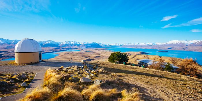 The view of the southern alps and Lake Alexandrina from Mt John Walkway and observatory area near Lake Tekapo on a clear spring evening in New Zealand