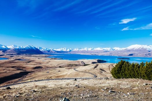 The view of the southern alps and Lake Alexandrina from Mt John Walkway and observatory area near Lake Tekapo on a clear spring evening in New Zealand
