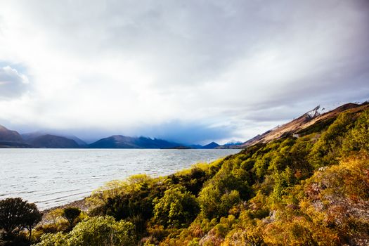 Lake Wakatipu and surrounding mountains, including Tooth Peaks from near Bennetts Bluff Lookout, on a sunny spring day approaching sunset near Glenorchy in New Zealand