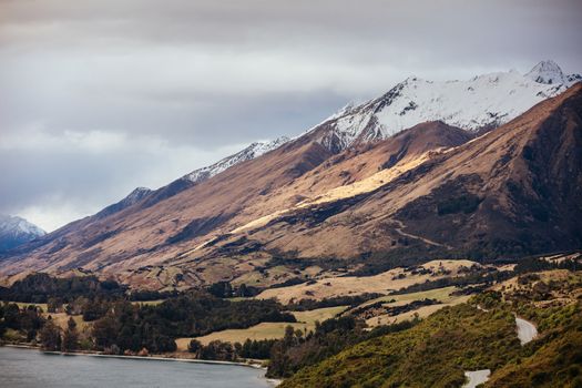 Lake Wakatipu and surrounding mountains, including Tooth Peaks from near Bennetts Bluff Lookout, on a sunny spring day approaching sunset near Glenorchy in New Zealand