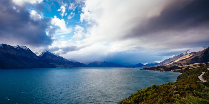 Lake Wakatipu and surrounding mountains, including Tooth Peaks from near Bennetts Bluff Lookout, on a sunny spring day approaching sunset near Glenorchy in New Zealand