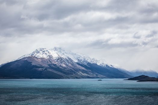 Lake Wakatipu and surrounding mountains, including Tooth Peaks from near Bennetts Bluff Lookout, on a sunny spring day approaching sunset near Glenorchy in New Zealand