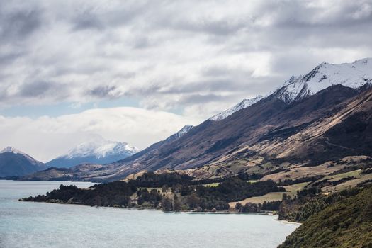 Lake Wakatipu and surrounding mountains, including Tooth Peaks from near Bennetts Bluff Lookout, on a sunny spring day approaching sunset near Glenorchy in New Zealand