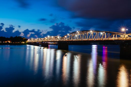 The iconic Truong Tien Bridge in Hue Vietnam at rush hour with lots of traffic on a warm and wet evening