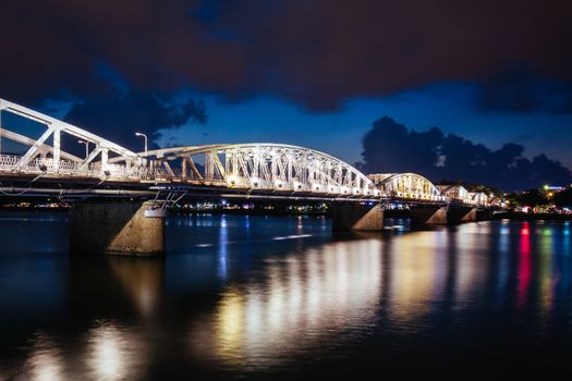 The iconic Truong Tien Bridge in Hue Vietnam at rush hour with lots of traffic on a warm and wet evening