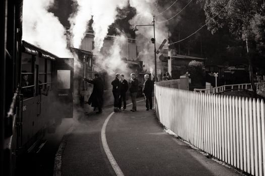 Melbourne, Australia - June 11 2012: Puffing Billy steam train travels across an old wooden bridge in Melbourne, Victoria, Australia