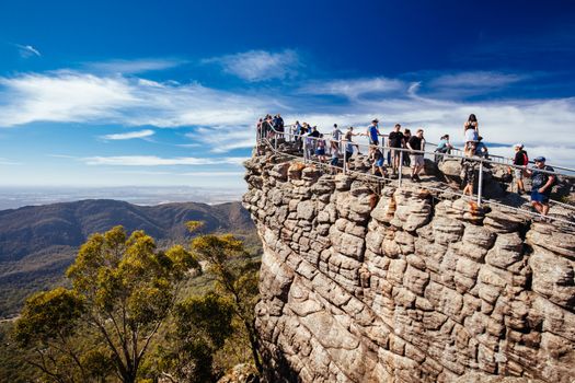 Crowds take in the iconic views from Pinnacle Lookout over Halls Gap and surrounds on the Wonderland hike loop in Victoria, Australia