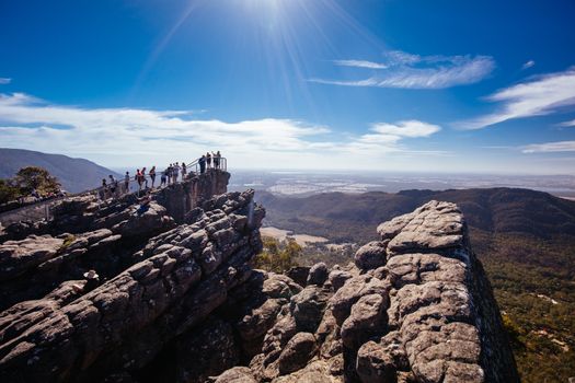 Crowds take in the iconic views from Pinnacle Lookout over Halls Gap and surrounds on the Wonderland hike loop in Victoria, Australia