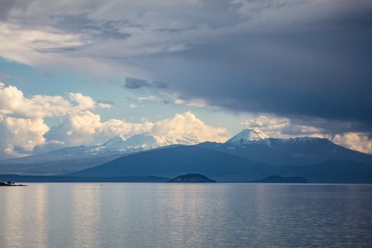 Storms rolling in over Tongariro National Park. The peaks of Mt Ruapehu and Mt Ngaurhoe can be seen at sunset in New Zealand