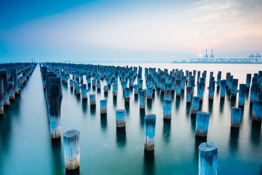 The historic Princes Pier featuring many disused pylons on a hot summer's day in Port Melbourme, Australia