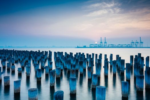 The historic Princes Pier featuring many disused pylons on a hot summer's day in Port Melbourme, Australia