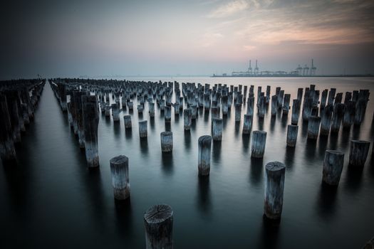The historic Princes Pier featuring many disused pylons on a hot summer's day in Port Melbourme, Australia