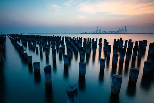 The historic Princes Pier featuring many disused pylons on a hot summer's day in Port Melbourme, Australia