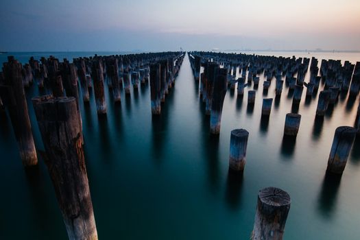The historic Princes Pier featuring many disused pylons on a hot summer's day in Port Melbourme, Australia