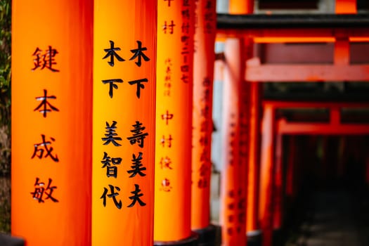 Red Tori Gate at Fushimi Inari Shrine in Kyoto, Japan. One of the largest tourist attractions in Japan