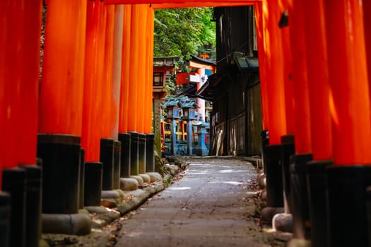 Red Tori Gate at Fushimi Inari Shrine in Kyoto, Japan. One of the largest tourist attractions in Japan