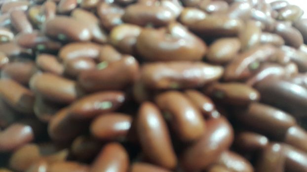 Kidenry beans:   Closeup view of uncooked red kidney beans. Dark red useful beans background.