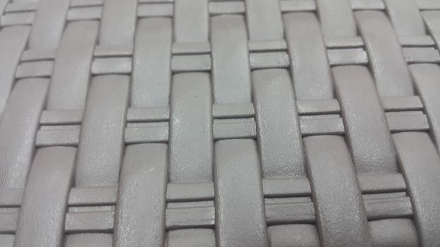 Grey plastic woven stripes of traditional bed, chair or sitting stool used in rural areas.