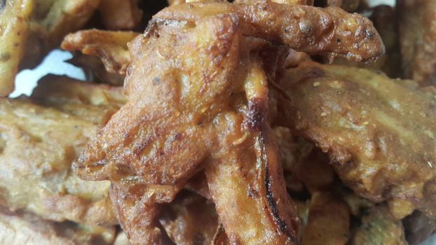 Crispy basin pakora/pakoda or patties are popular indian or pakistani street food snack, served with green salad and sauce. Selective focus of