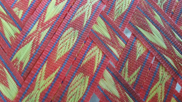 Colorful plastic woven stripes of traditional bed used in rural areas.