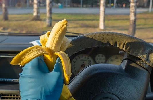 quick, safe food, banana in the car driver hand