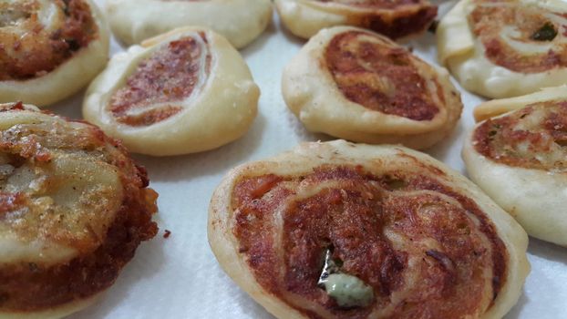 Closeup of delicious home made pinwheel puff pastries food item placed over white background
