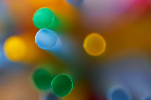 Blurred Background Multicolored Plastic Drinks Tubes. High quality photo