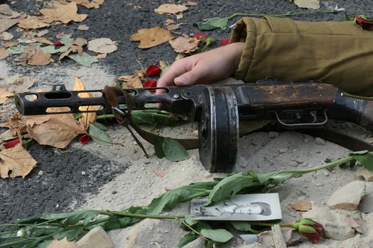 Fallen soldier with drum machine gun.