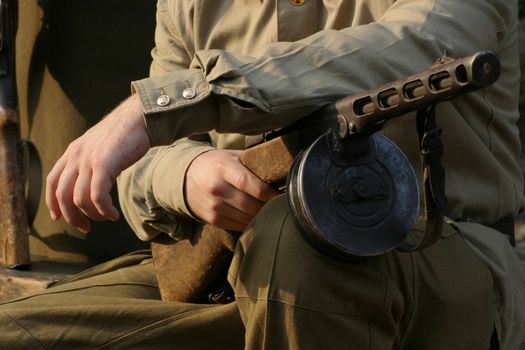 Soldier with drum machine gun in hand.