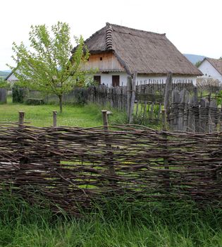 Country house with wicker cane fence.