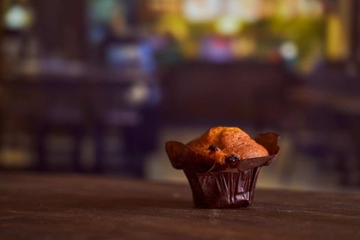 Chocolate maffin on a wooden table with chocolate and tartallini . High quality photo