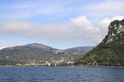 The view from Bardelino around the Rocca Di Garda headland towards Garda.  Garda is a resort town on the edge of Lake Garda in North East Italy.