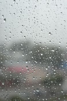 Drops of rain on the window, rainy day. Shallow DOF