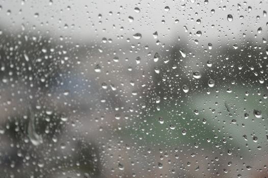 Drops of rain on the window, rainy day. Shallow DOF