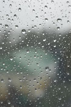 Drops of rain on the window, rainy day. Shallow DOF