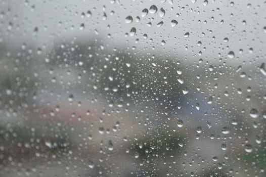 Drops of rain on the window, rainy day. Shallow DOF